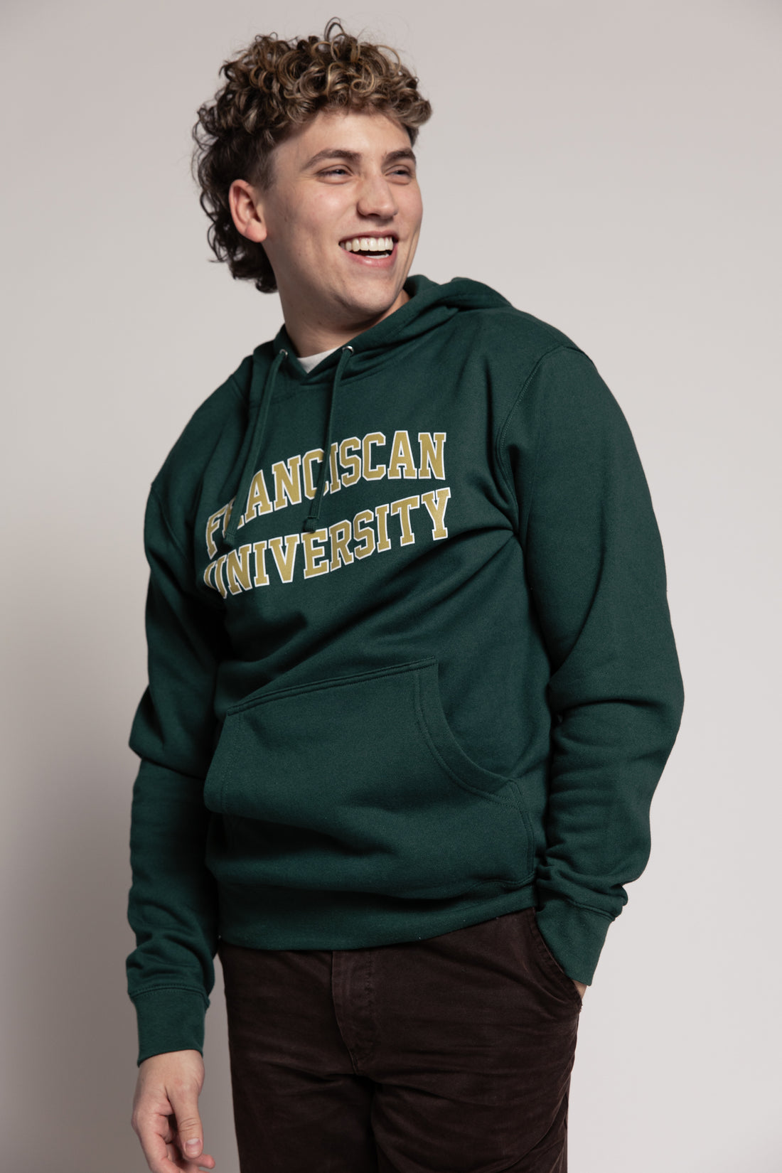 Person wearing a green hoodie with &