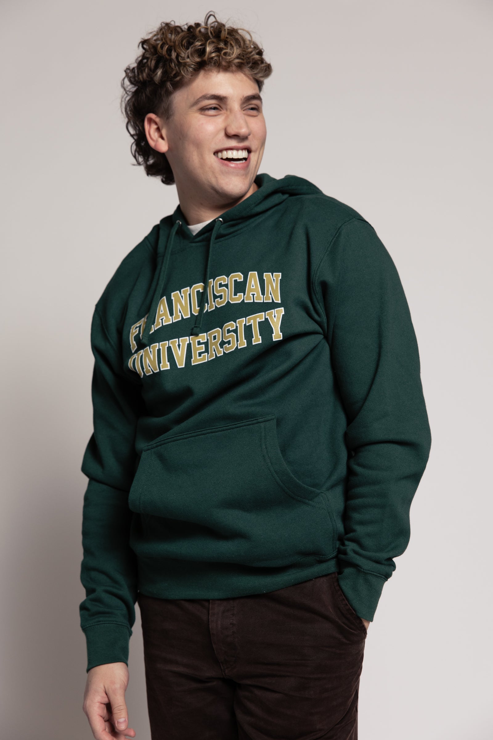 Person wearing a green hoodie with &